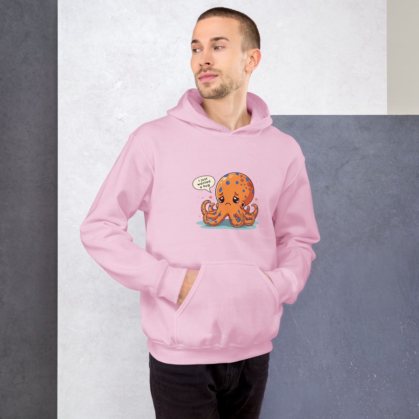 man wearing a pink hoodie with a blue ringed octopus design in the front