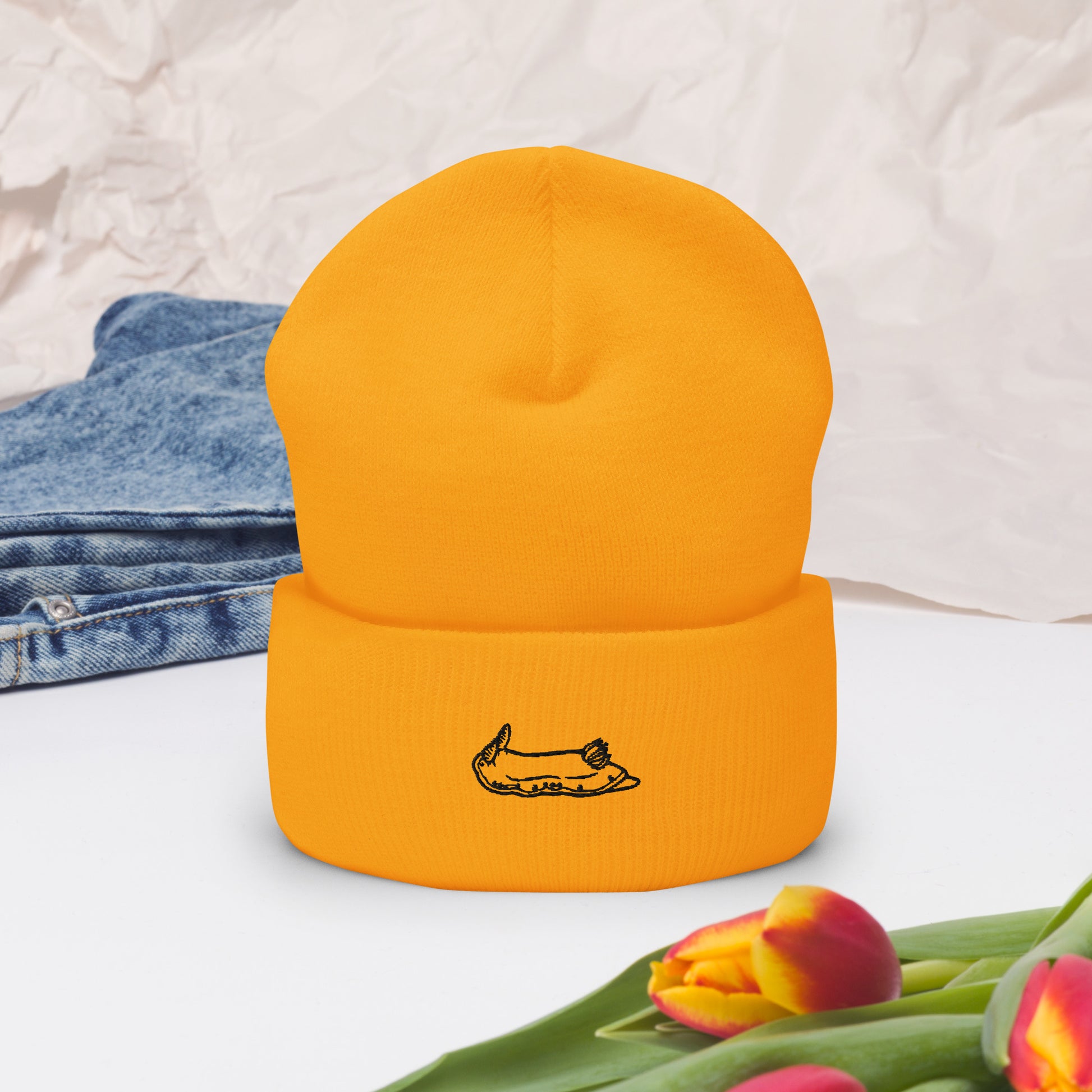 yellow beanie with a black nudibranch embroidery logo