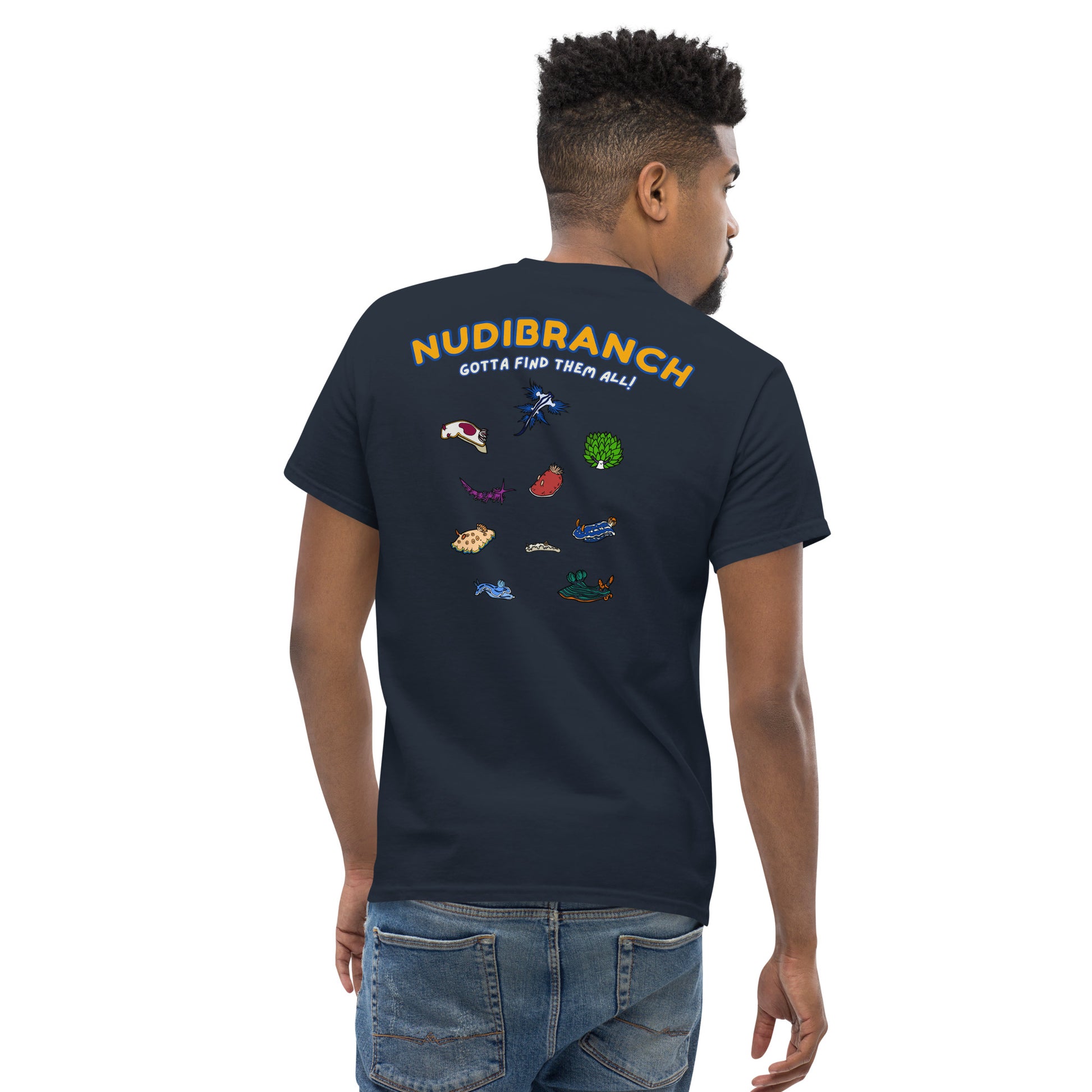 Man wearing a navy colored t shirt with a logo of multiple colored nudibranch and written nudibranch in yellow and gotta find them all in white, back view