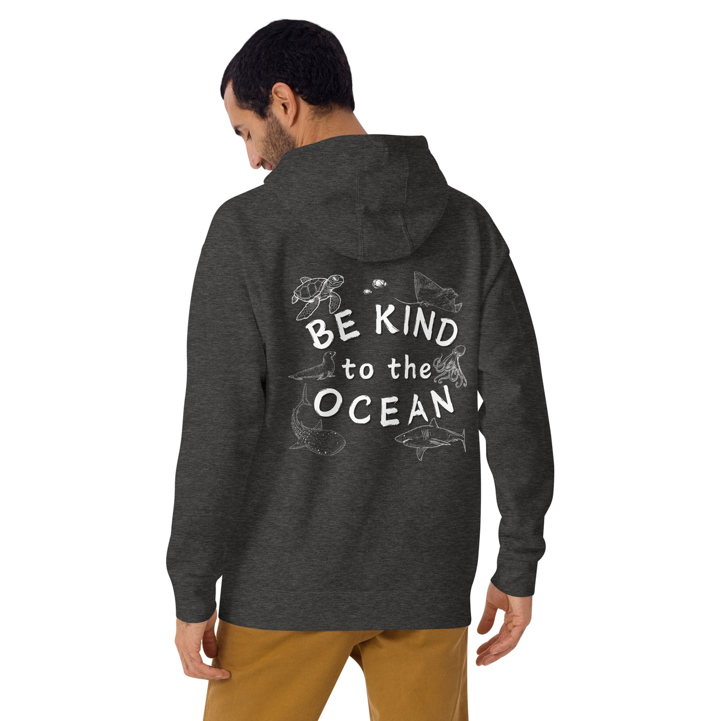 Man wearing a charcoal hoodie with the logo written be kind to the ocean with marine animals around it