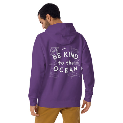 Man wearing a purple hoodie with the logo written be kind to the ocean with marine animals around it