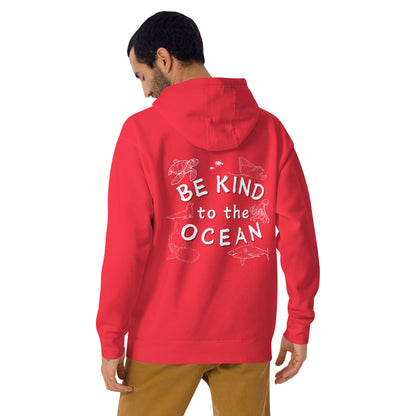 Man wearing a red hoodie with the logo written be kind to the ocean with marine animals around it