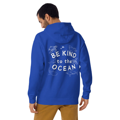 Man wearing a blue hoodie with the logo written be kind to the ocean with marine animals around it