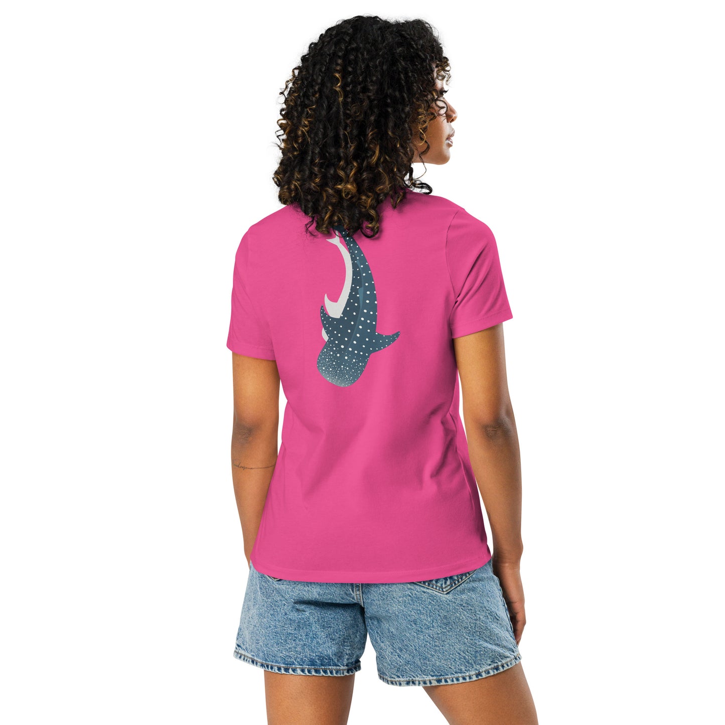 A woman wearing a pink shirt with a large logo of a whale shark pointing down on the back side