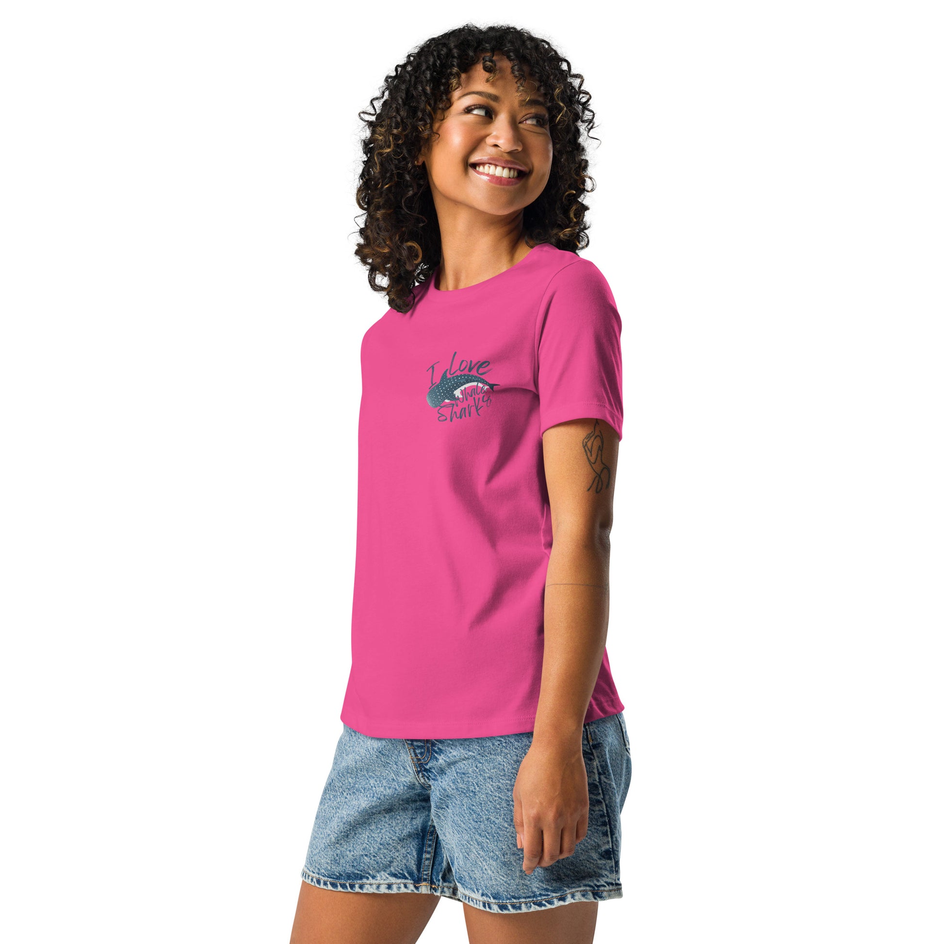 A woman wearing a pink shirt with a logo of a whale shark and the words I love whale sharks on the front around it