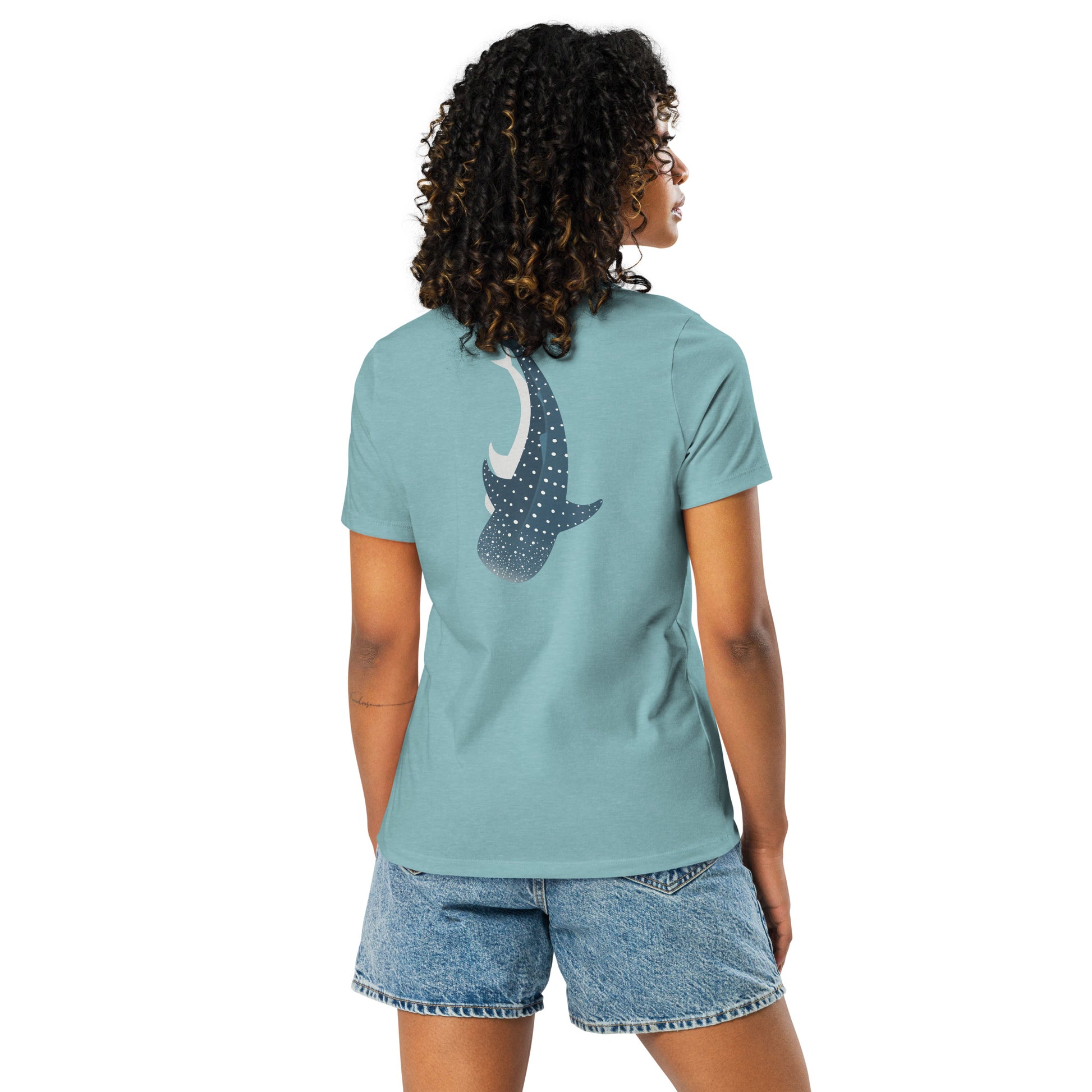 A woman wearing a blue shirt with a large logo of a whale shark pointing down on the back side