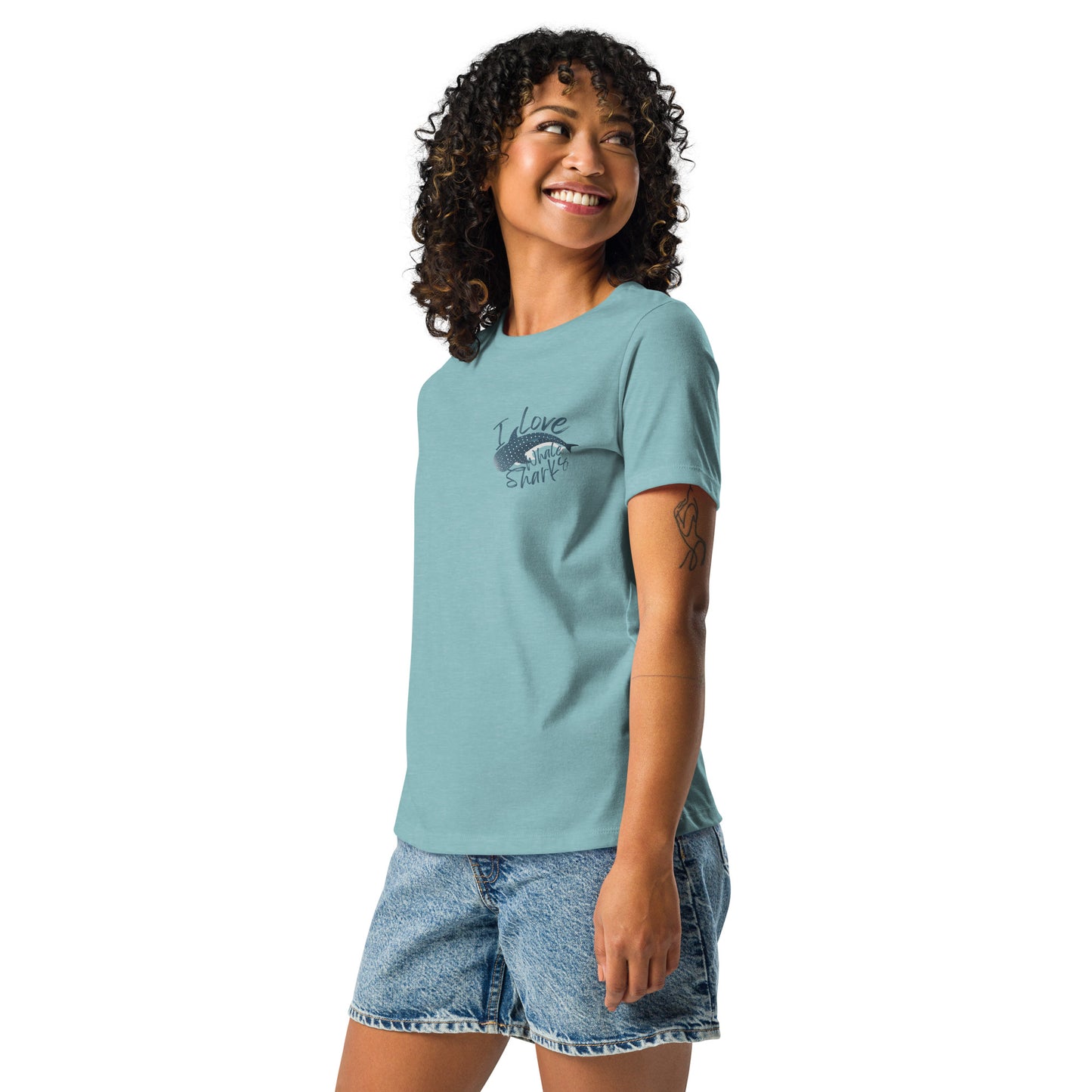 A woman wearing a blue shirt with a logo of a whale shark and the words I love whale sharks on the front around it