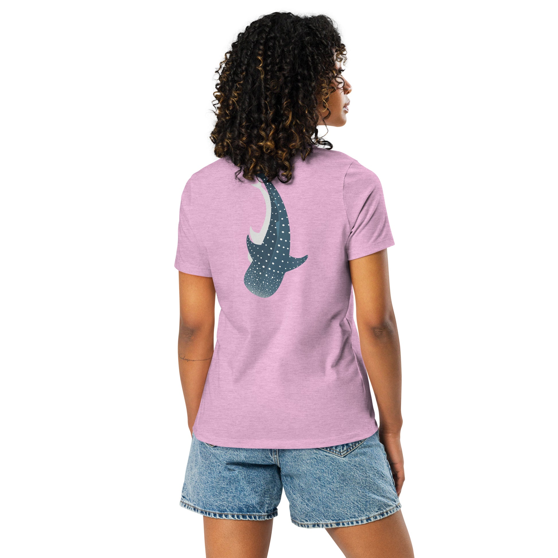 A woman wearing a lilac shirt with a large logo of a whale shark pointing down on the back side