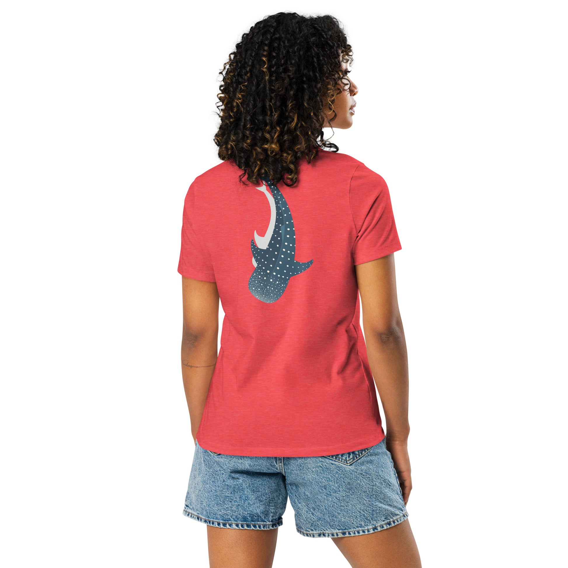 A woman wearing a red shirt with a large logo of a whale shark pointing down on the back side