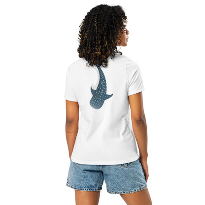 A woman wearing a white shirt with a large logo of a whale shark pointing down on the back side