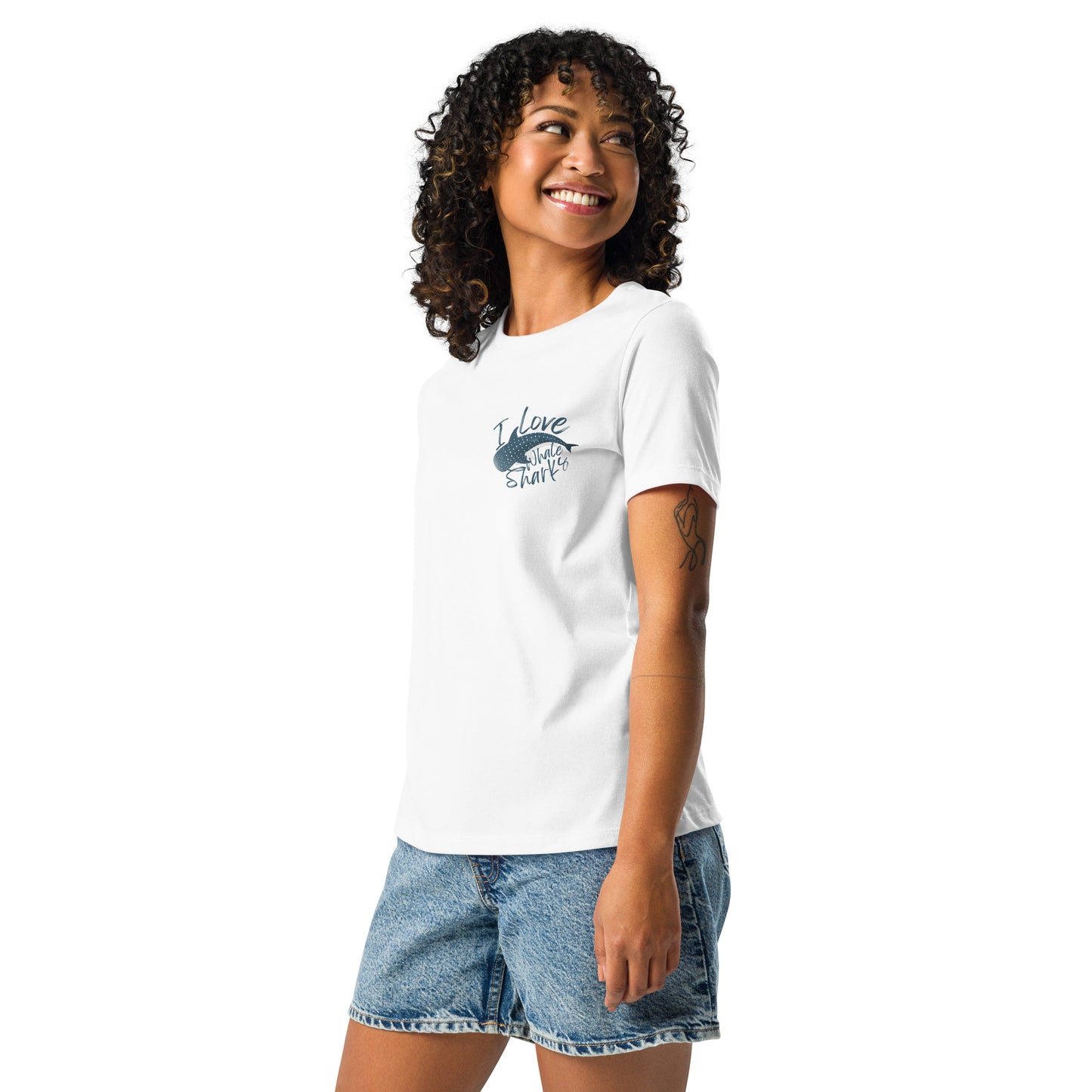 A woman wearing a white shirt with a logo of a whale shark and the words I love whale sharks on the front around it